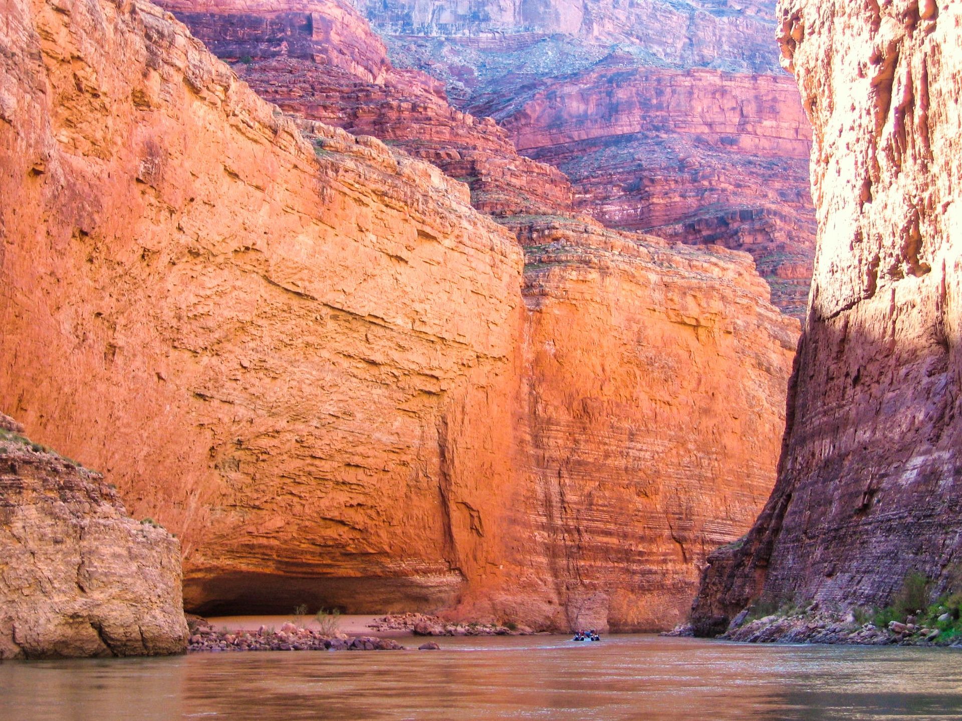 The sandstone overhang of Redwall Cavern seen from the river
