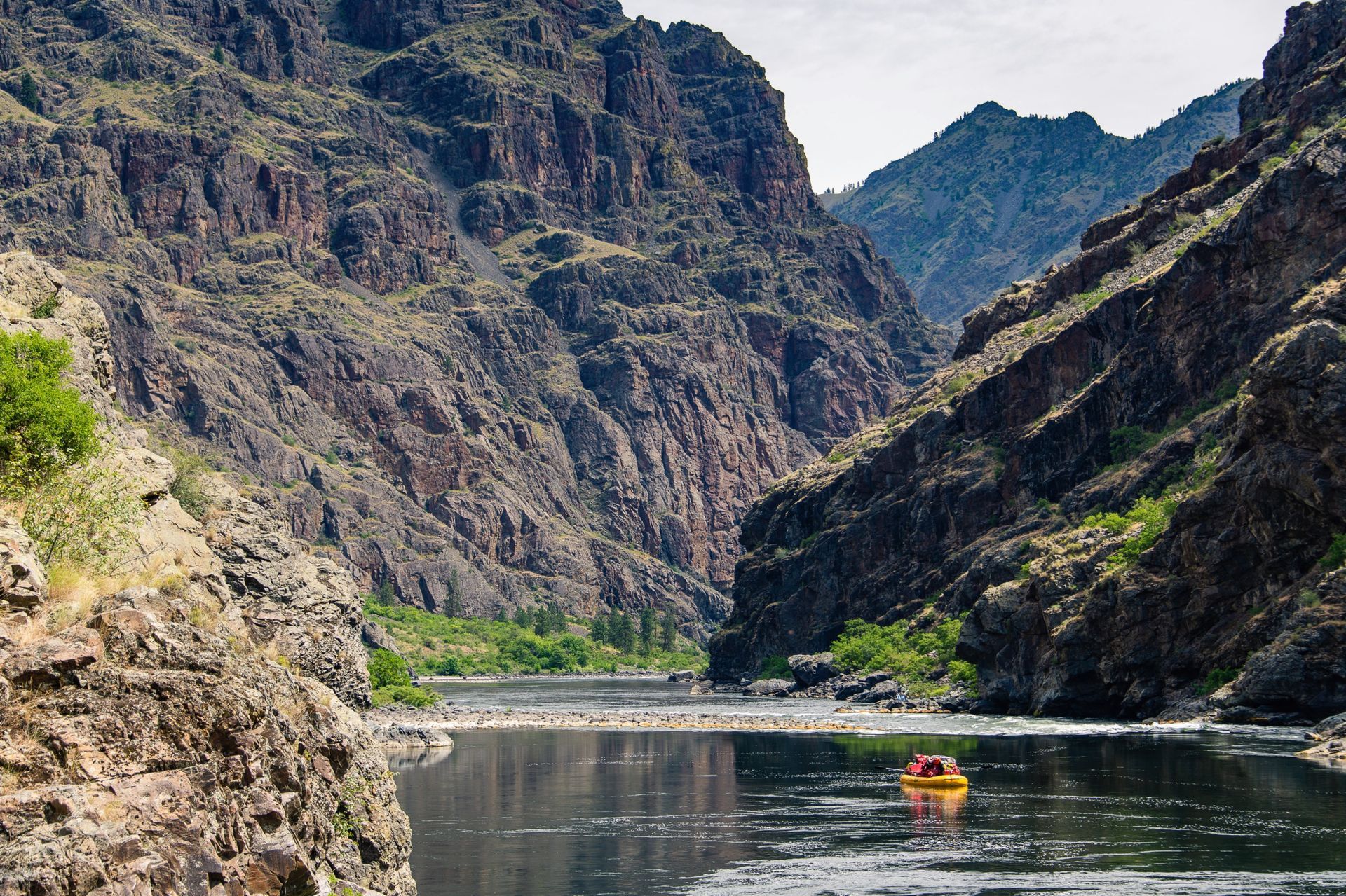 A raft floats through a quiet stretch of Hells Canyon