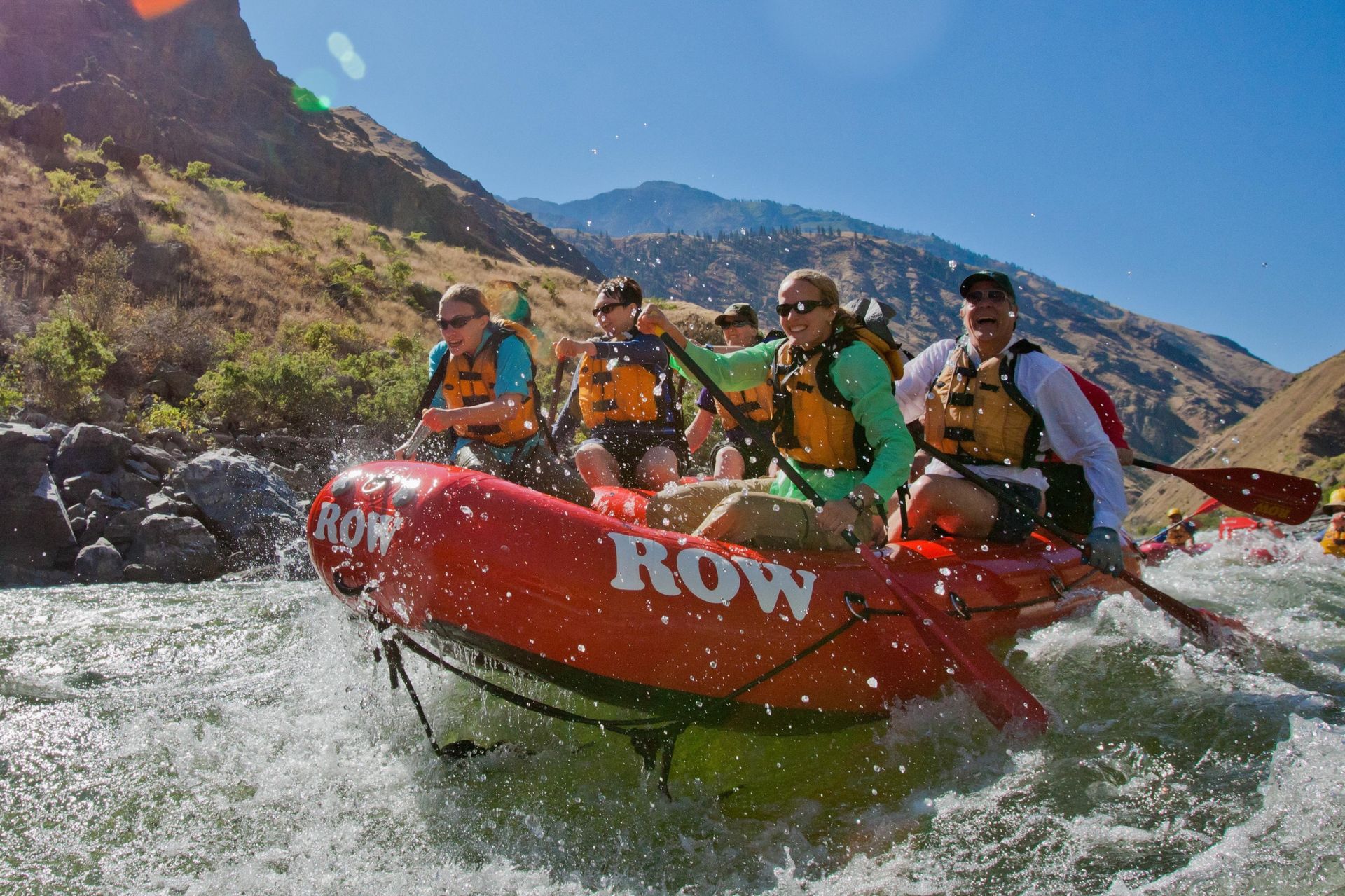 Paddlers in a red raft run a Hells Canyon rapid