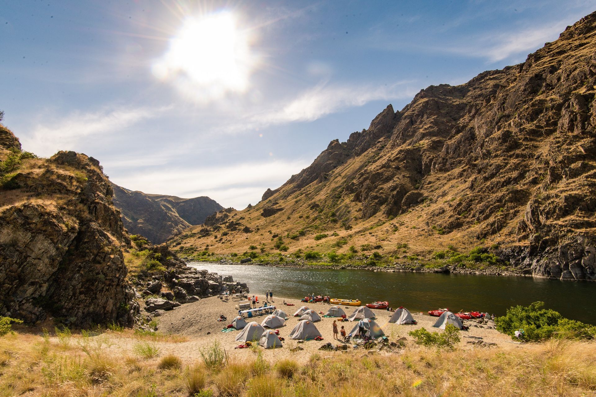 A riverside camp beneath Hells Canyon’s sunlit slopes