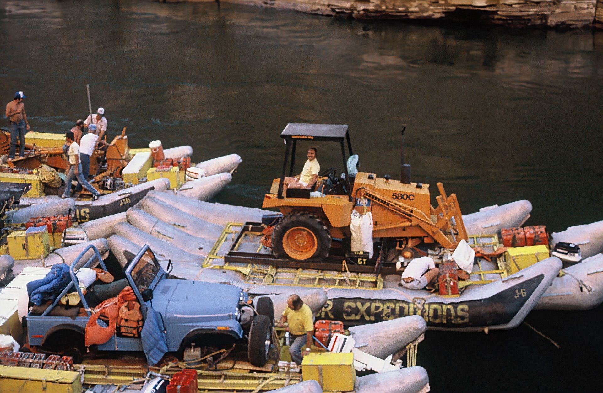 A backhoe and equipment loaded on J-Rig rafts in Grand Canyon