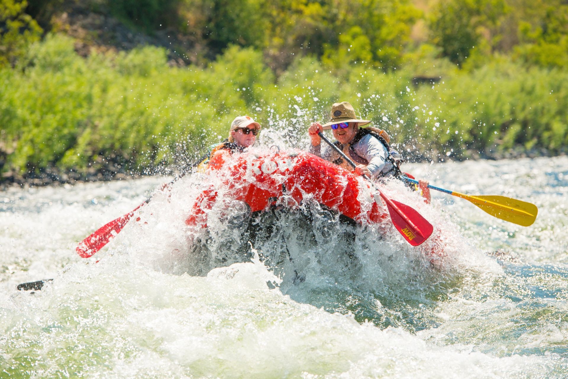 Paddlers in a red raft splash through a Lower Salmon River rapid
