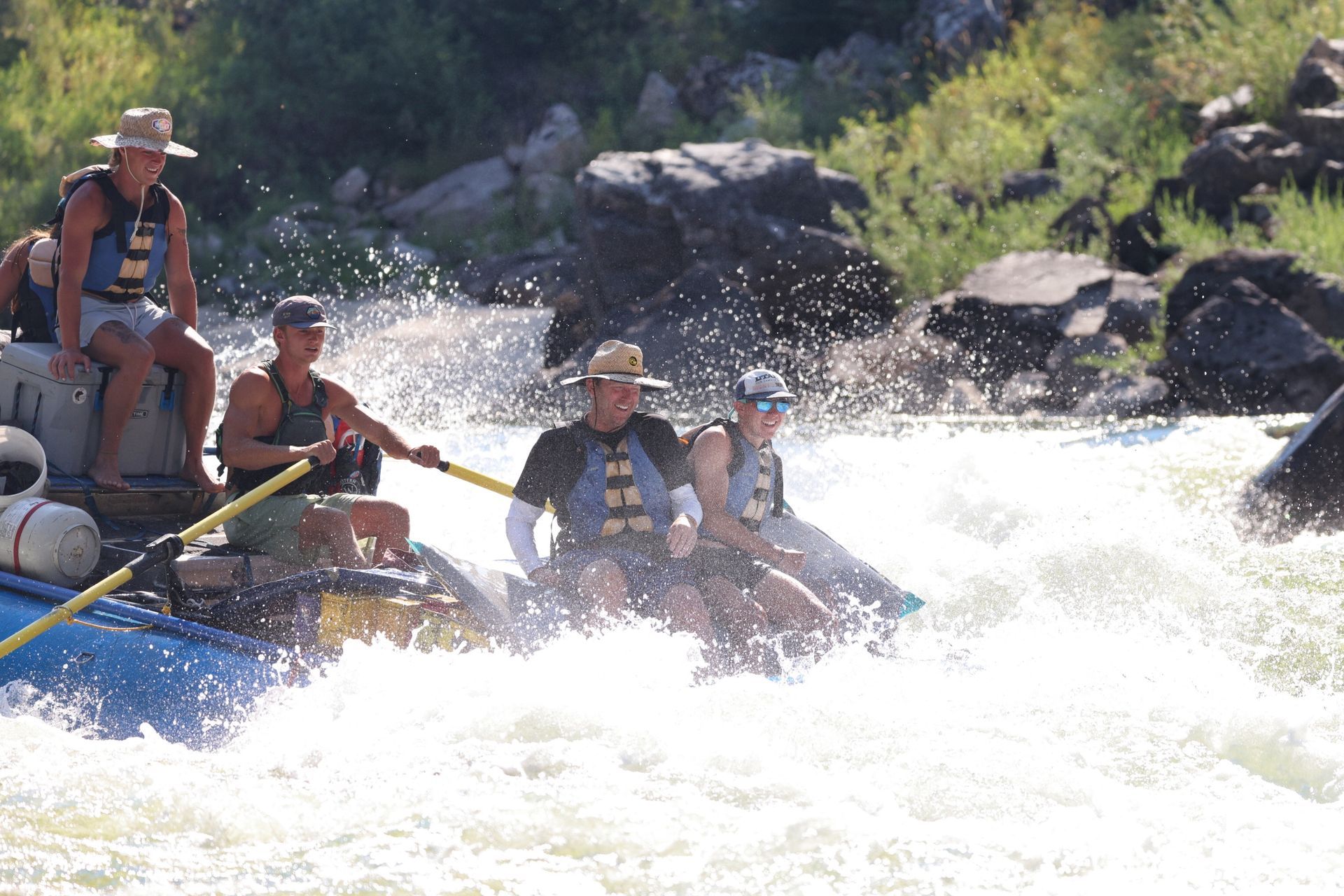 An oar boat splashes through a Main Salmon River rapid