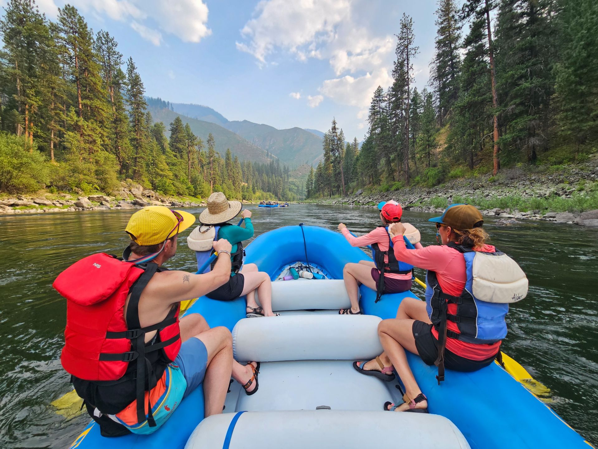 Paddlers look downstream from a blue raft on the Salmon River