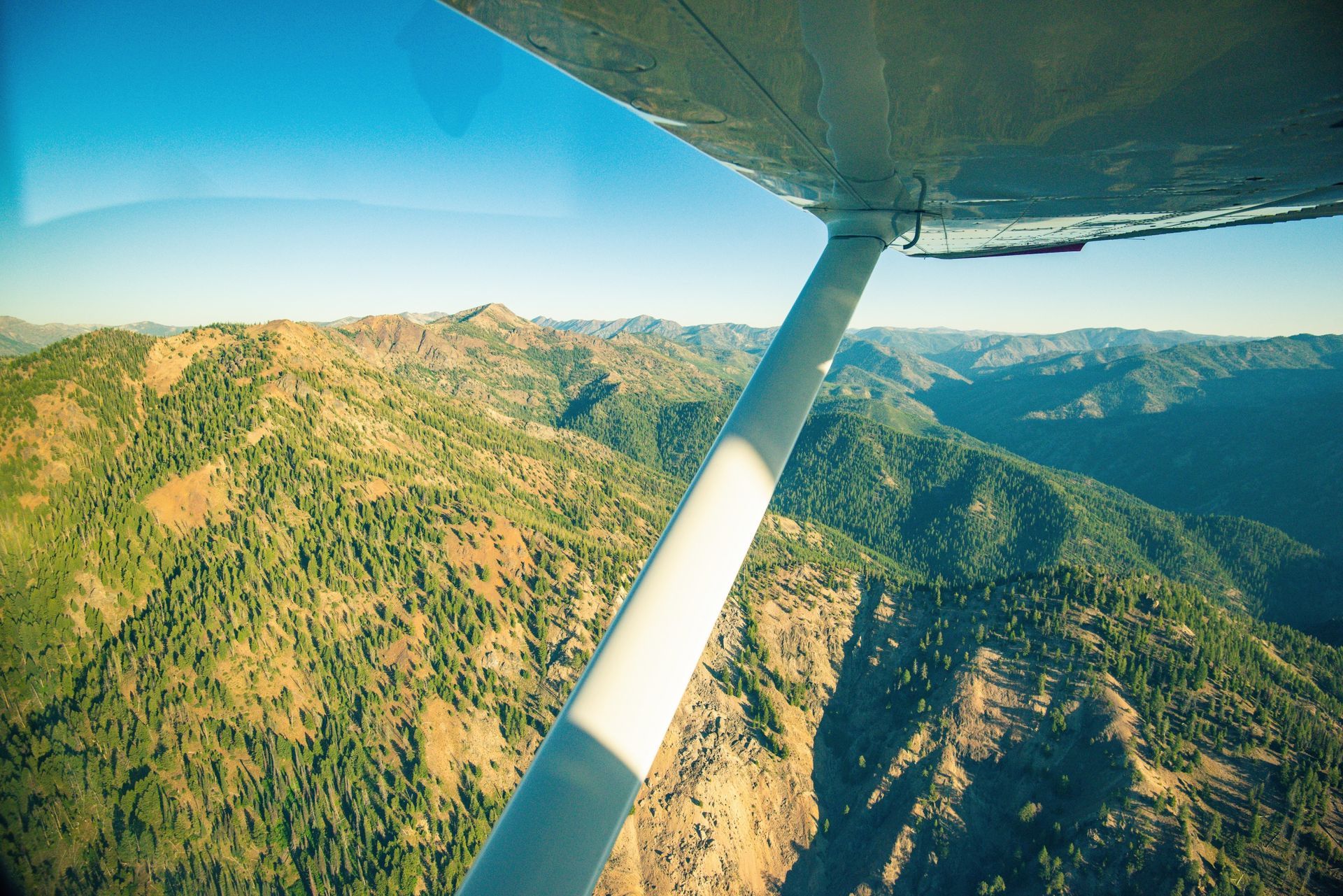 Mountain and canyon views from the window of a small plane