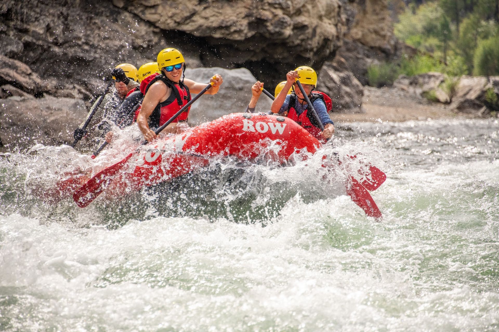 A red paddle raft splashes through a Middle Fork Salmon River rapid