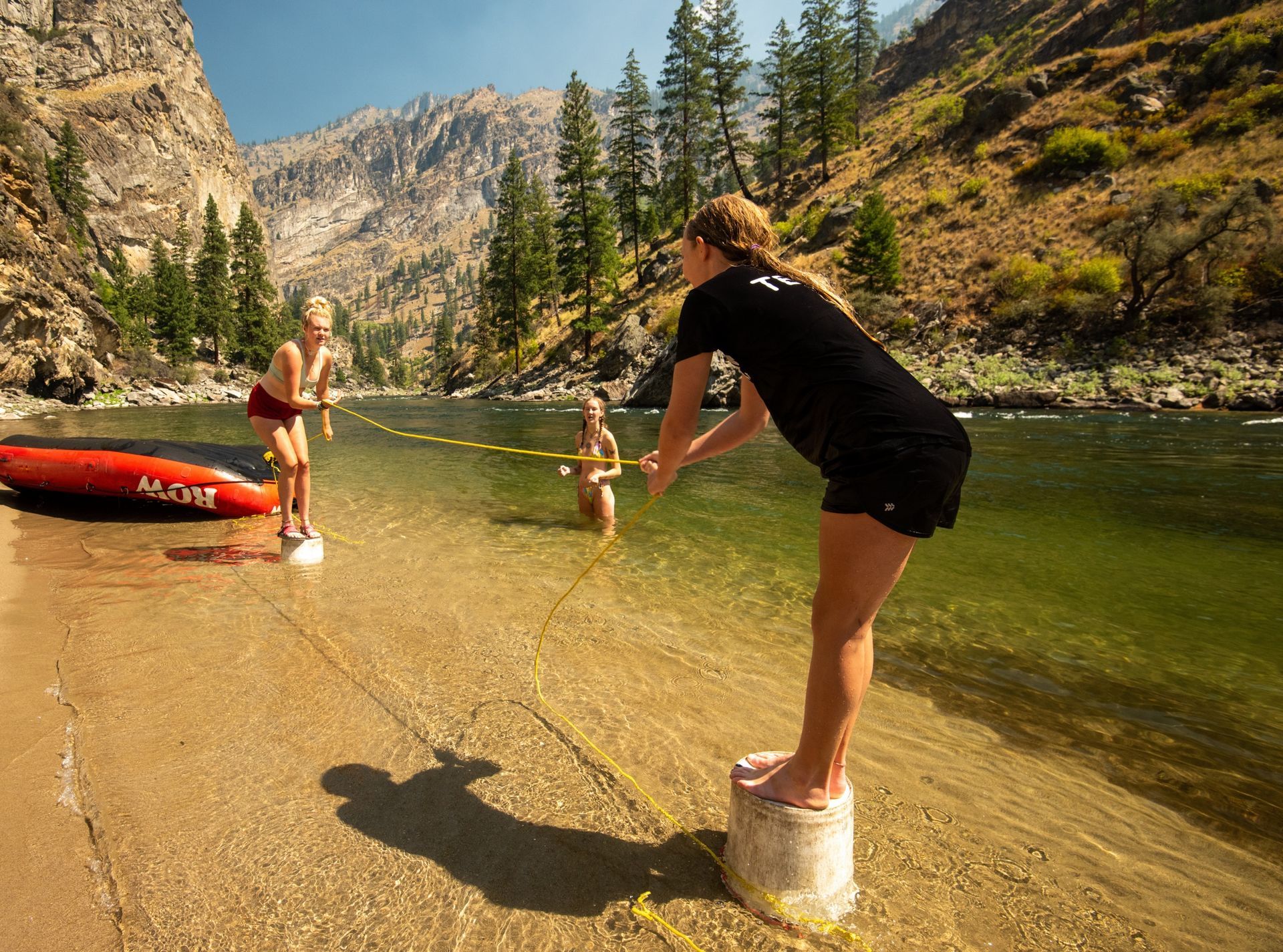 Rafters play tug-of-war in shallow river water