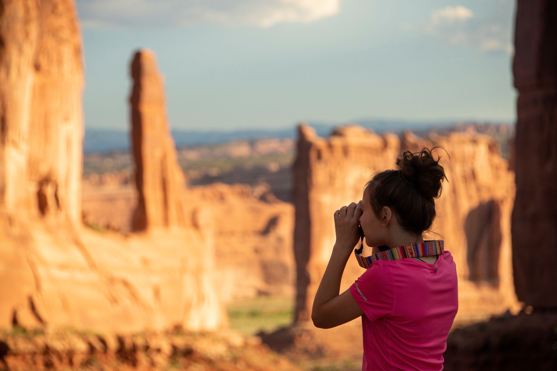 A visitor photographs Park Avenue’s sandstone formations