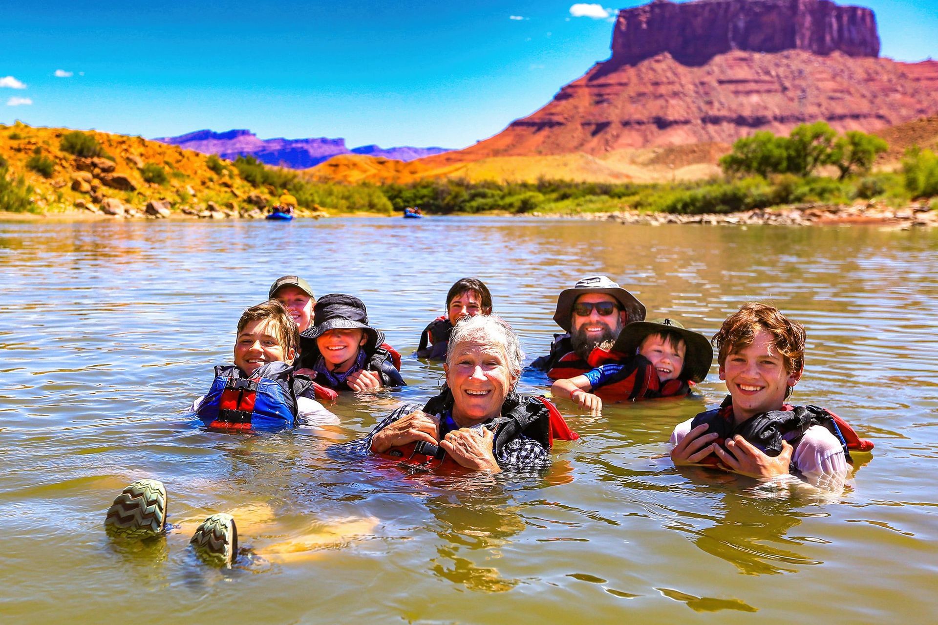 A family floats together in the Colorado River near Moab