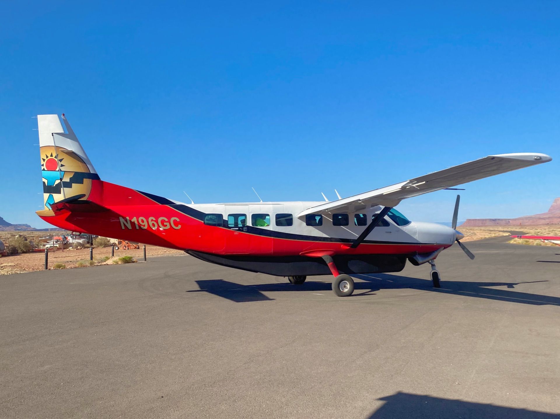 A small passenger plane parked on an airport apron