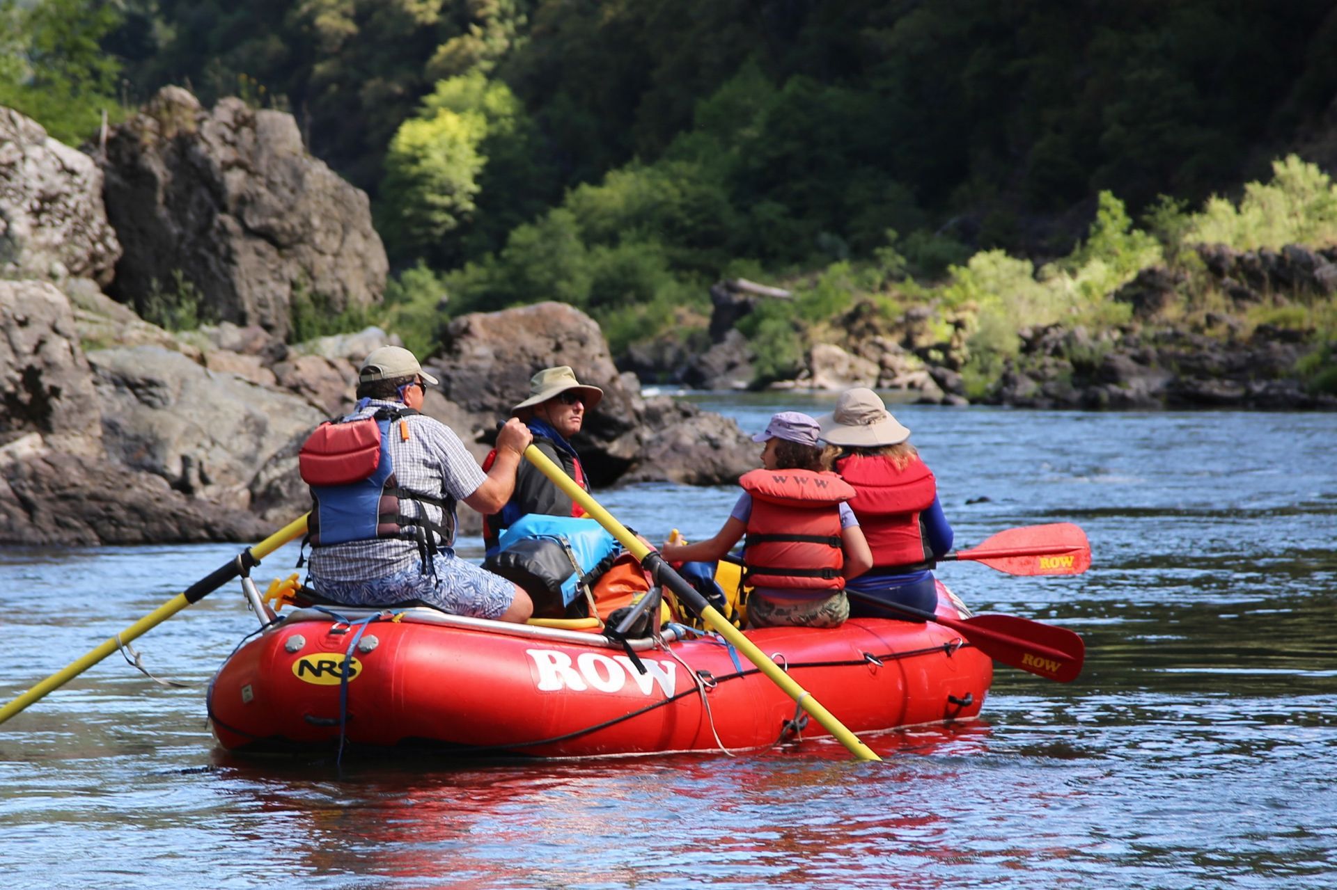 A guide rows guests along a calm section of the Rogue River