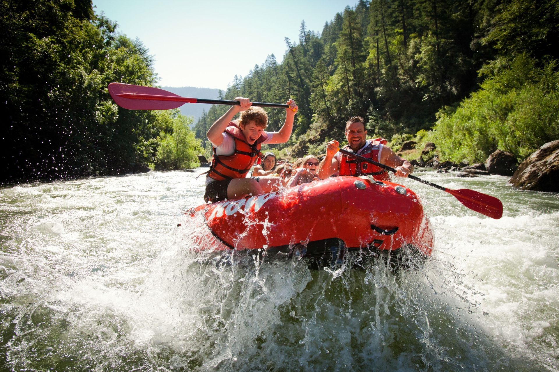 Paddle raft guests navigating a Rogue River rapid