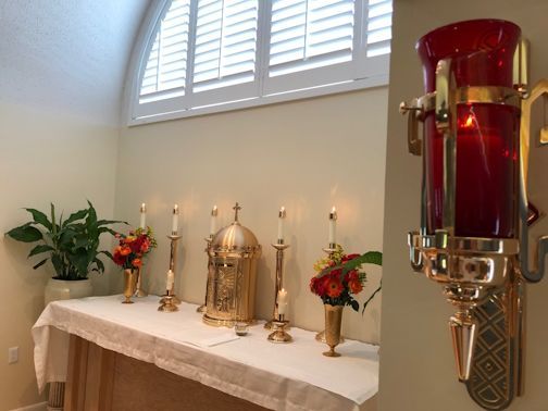 A church altar with candles and flowers on it