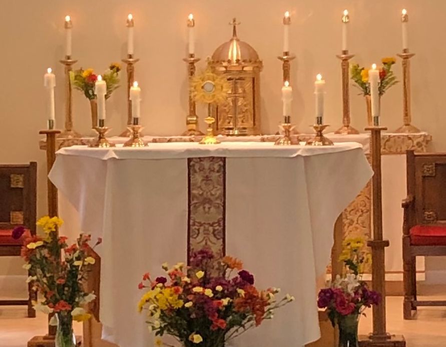 A church altar with flowers and candles on it
