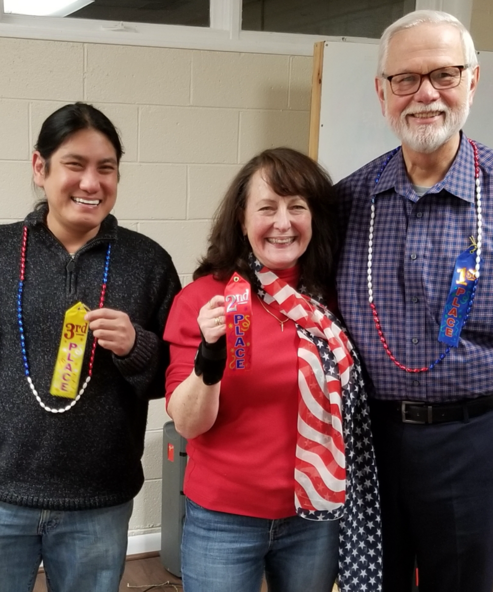 Three people posing for a picture for our 4th of July chili cookoff