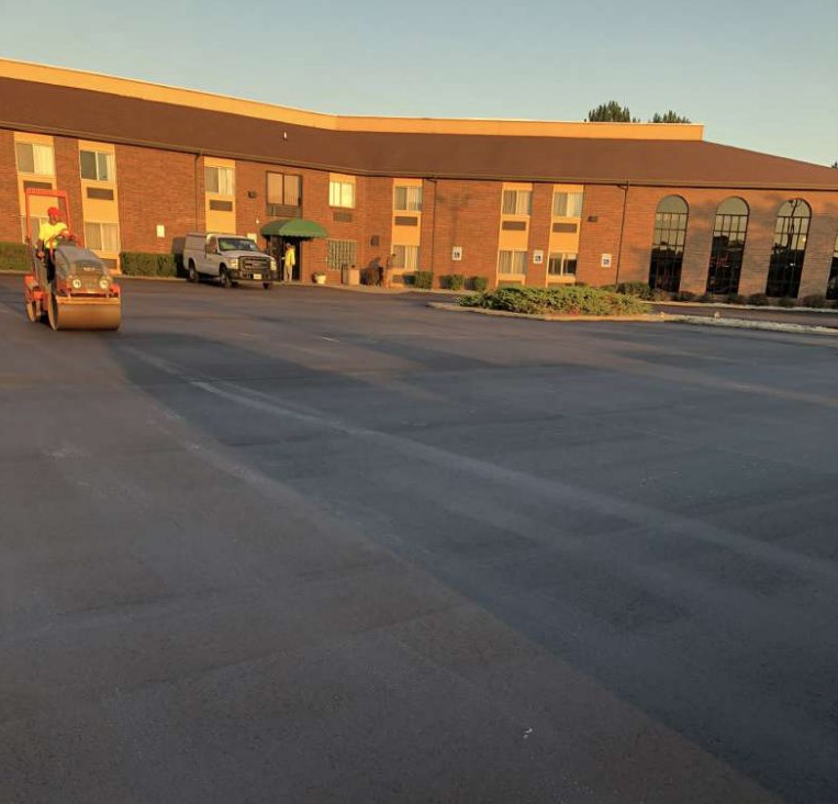 A large brick building with a parking lot in front of it
