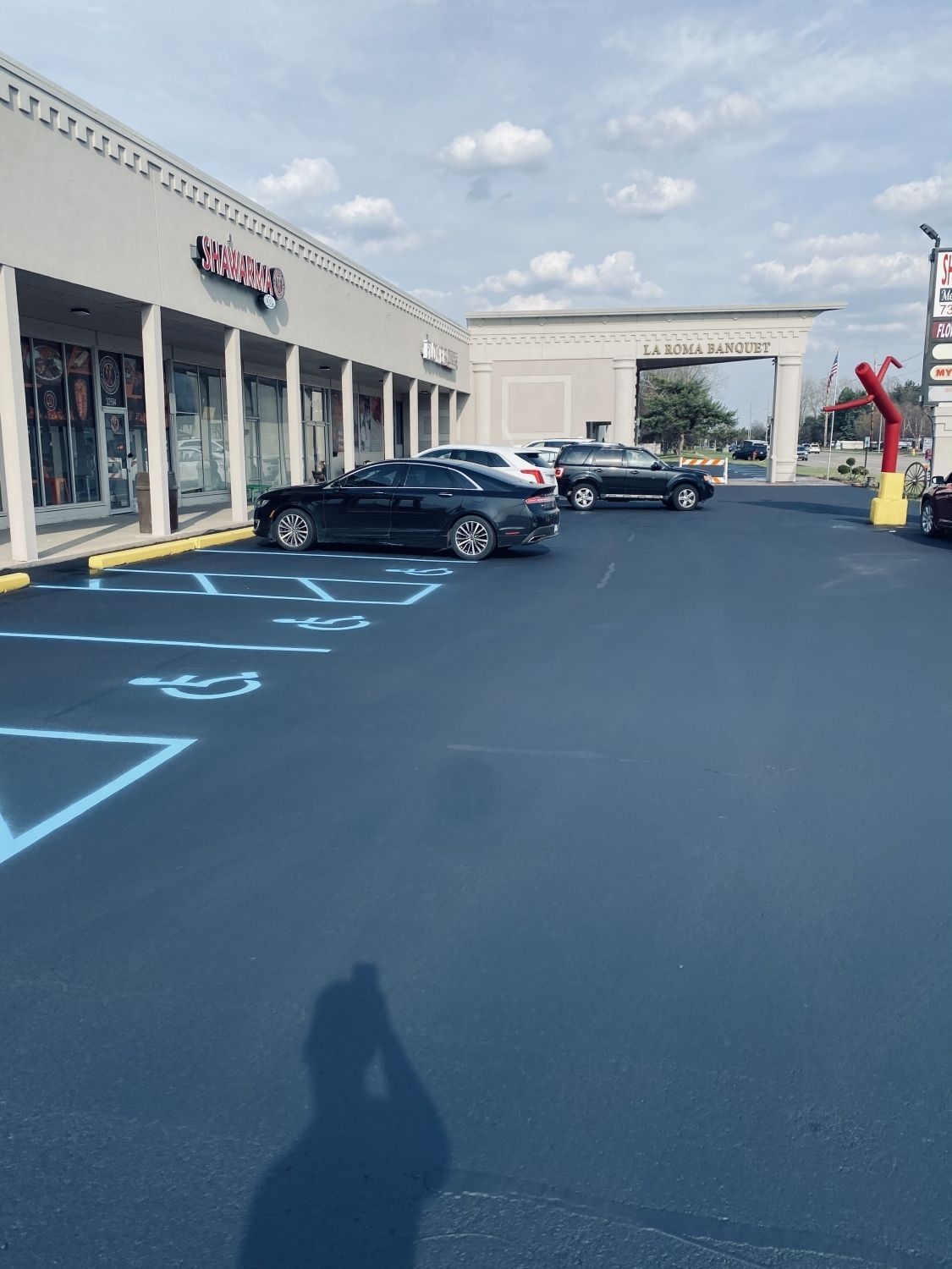 A parking lot with cars parked in front of a store
