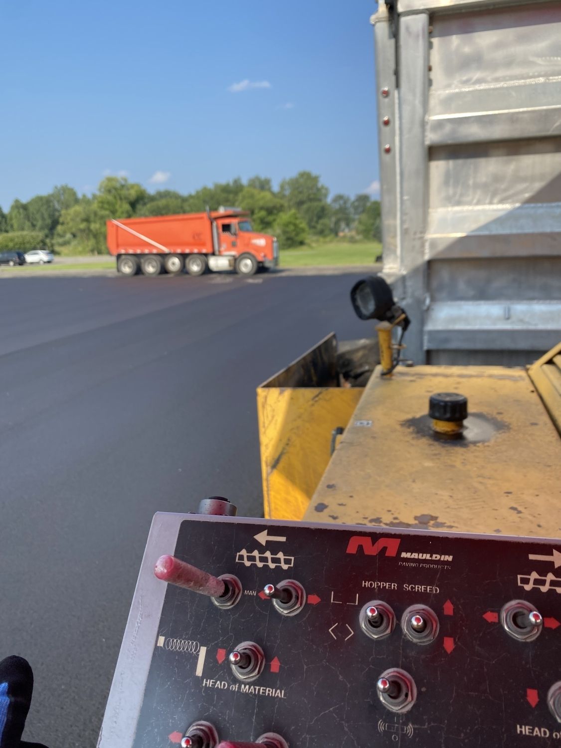 A truck is driving past a control panel that says mc on it