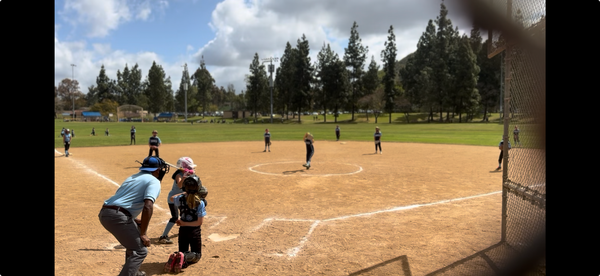 Baseball on a dark surface, with visible stitching.