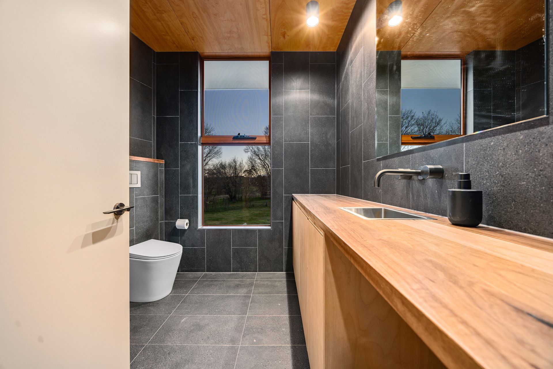 Modern Bathroom With Wood Vanity, Gray Tile — Croker Plumbing and Gas in Goulburn, NSW