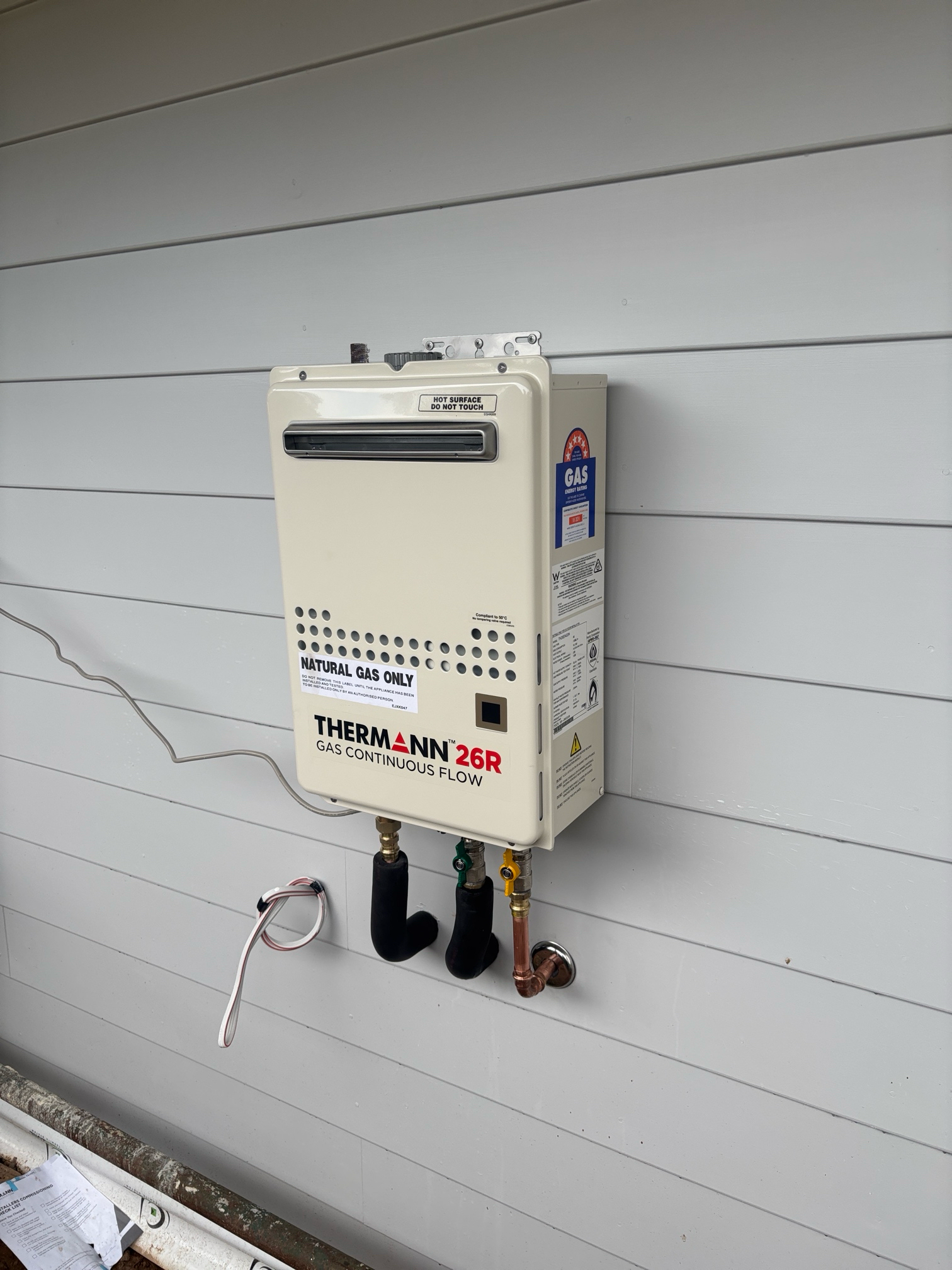 Tankless Water Heater Mounted on a Gray — Croker Plumbing and Gas in Goulburn, NSW