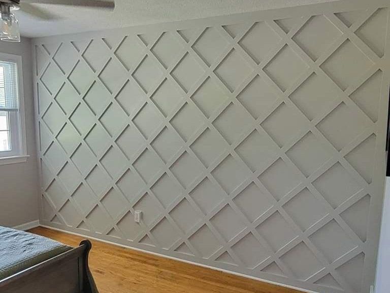 A bedroom in lancaster pa with a bed and a custom 3d accent wall with a pattern on it