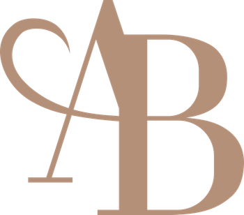 A brown letter b with a swirl around it on a white background.