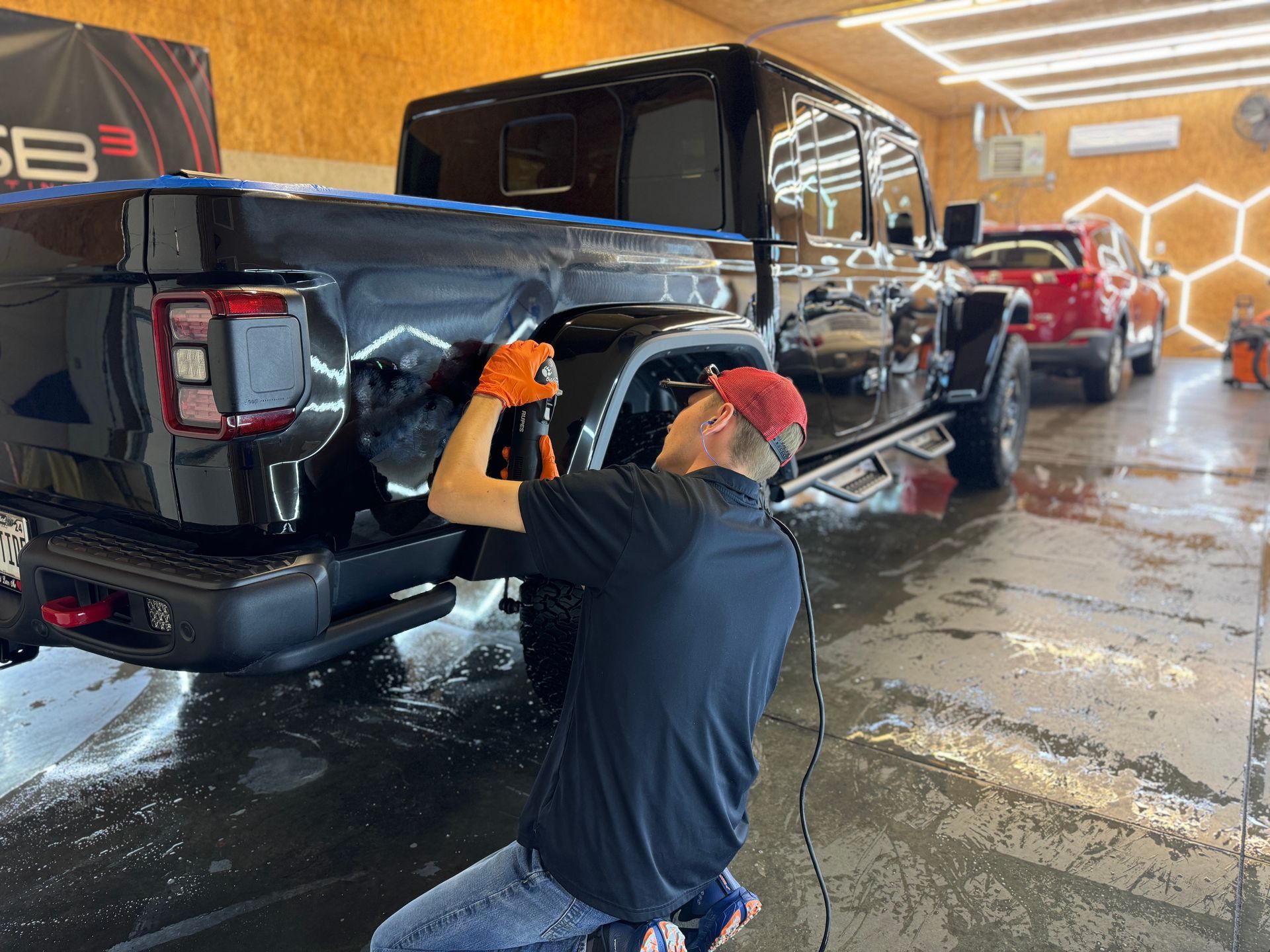 Our lead ceramic coating installer prepping a customer Jeep Glaidator