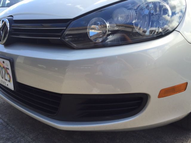 a silver volkswagen with a florida license plate