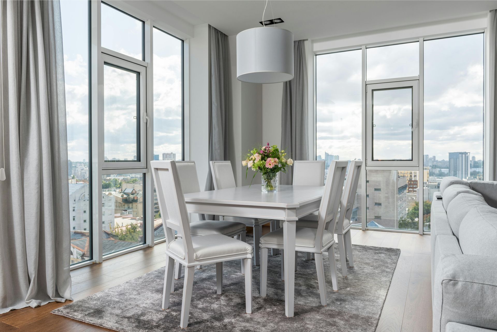 A vase of flowers is sitting on a table next to a window.