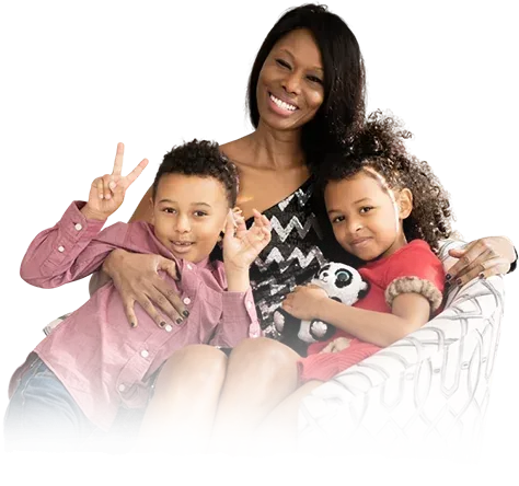Rosebell Murigu with two children on a couch, one child making a peace sign.
