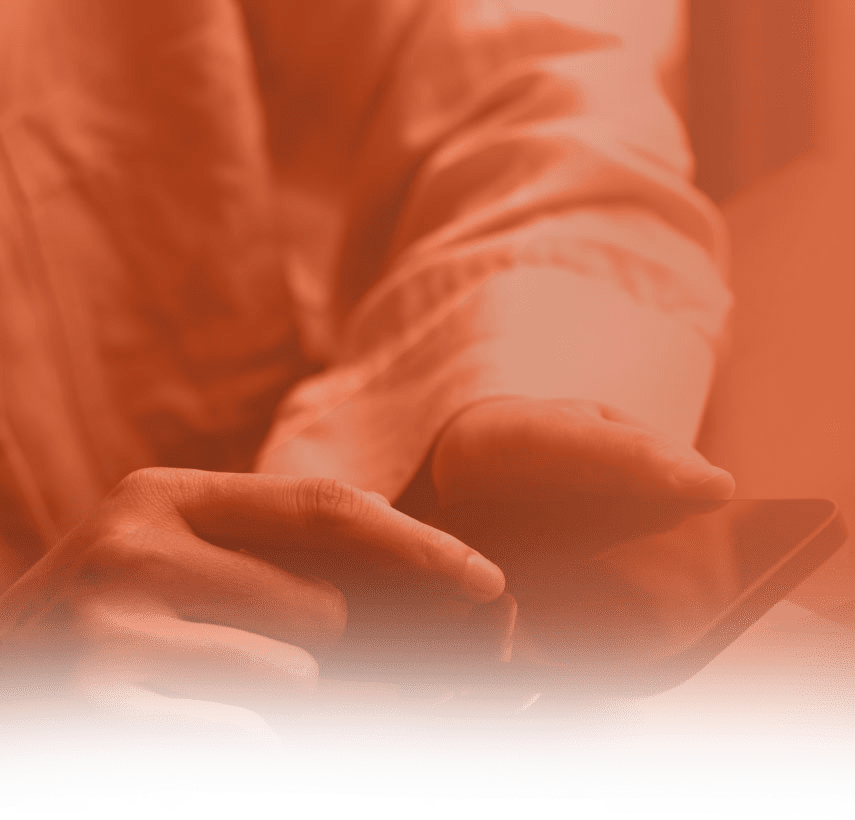 Hands using a smartphone, tinted in warm orange light