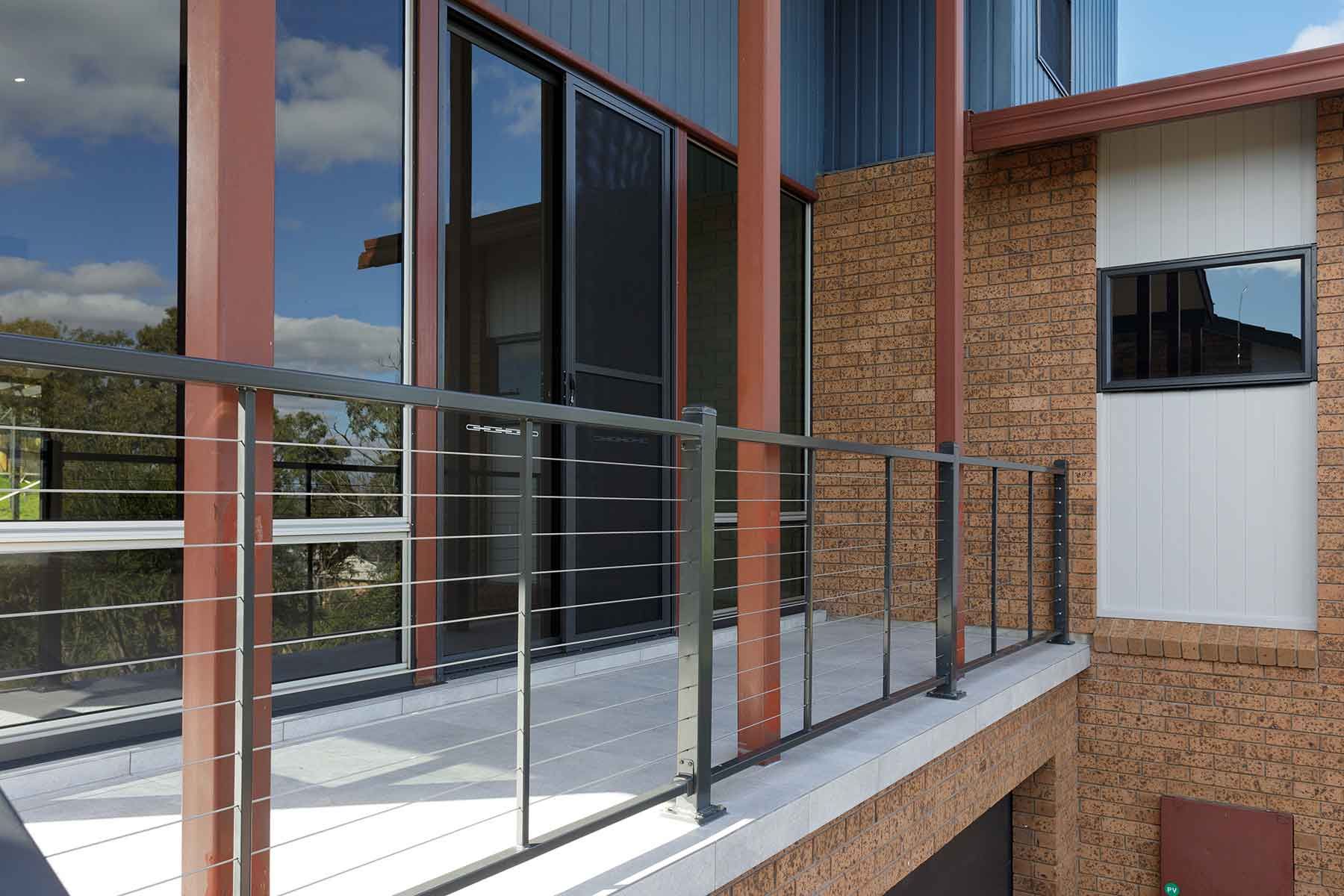 A Balcony With a Metal Railing on the Side of a Building — Kareela Constructions In Tamworth, NSW