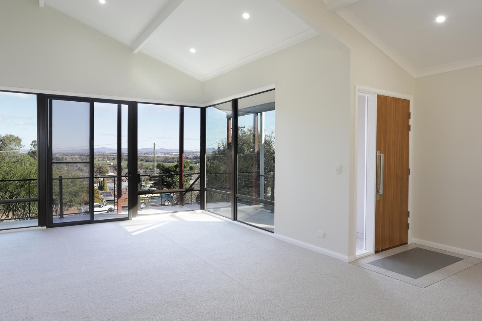 An Empty Room With a Lot of Windows and a Door — Kareela Constructions In Tamworth, NSW