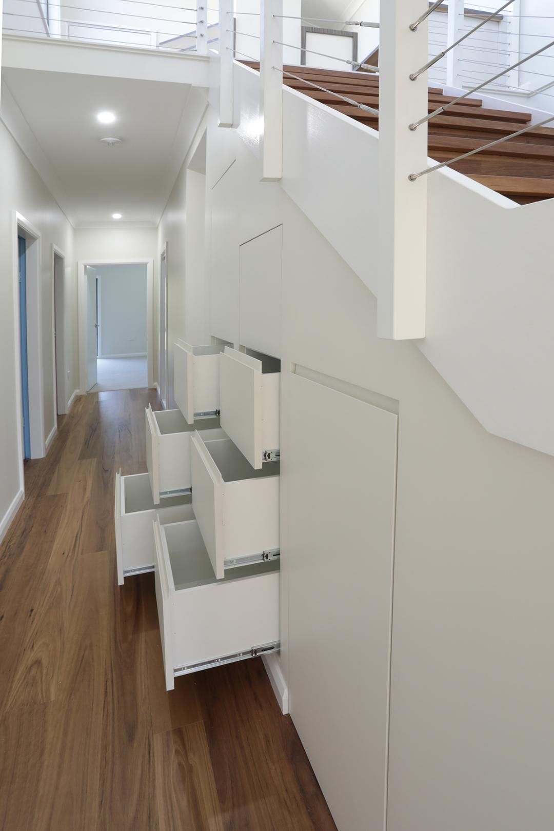 A Hallway With a Staircase and Drawers Underneath It — Kareela Constructions In Tamworth, NSW