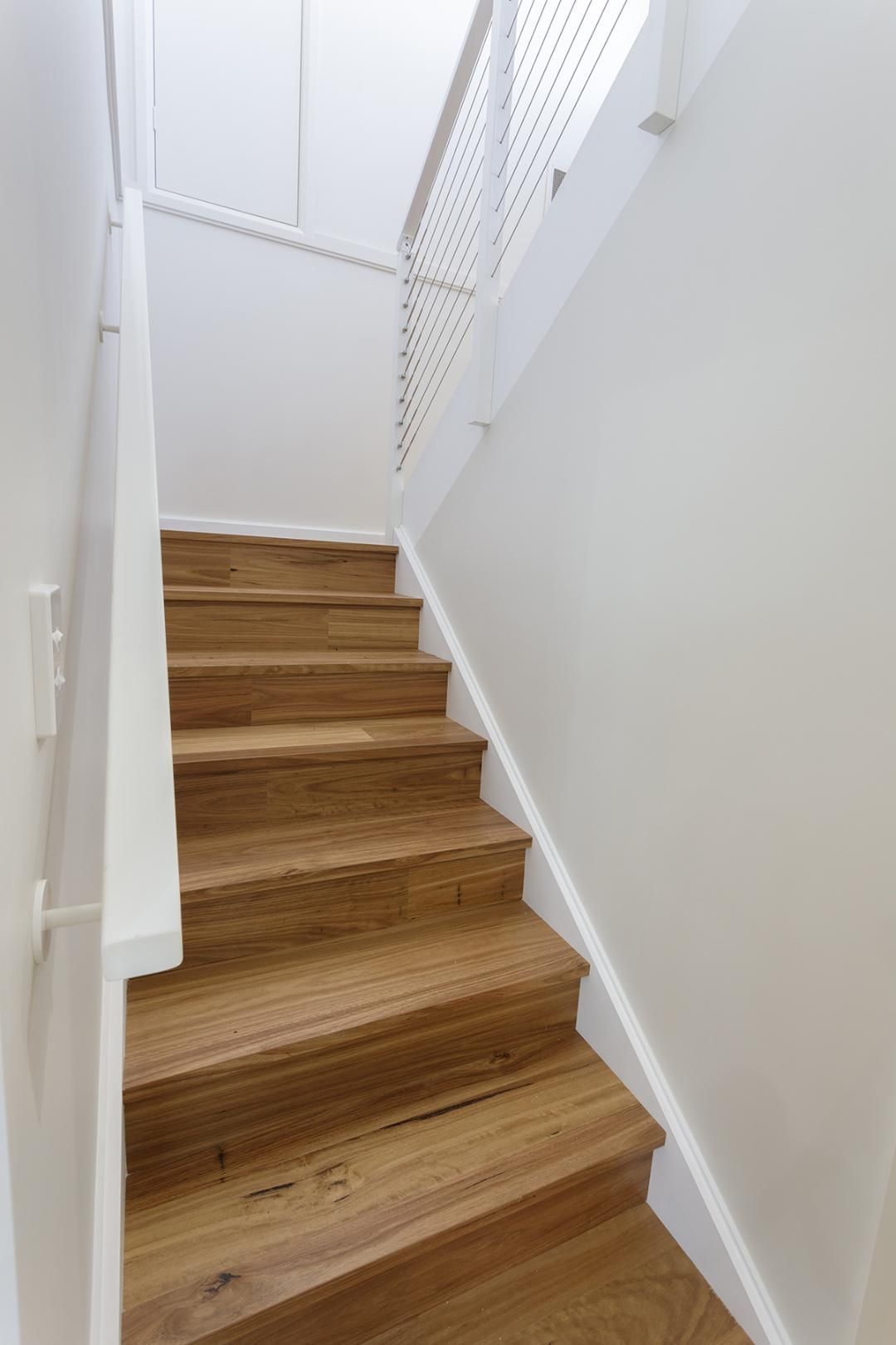 A Hallway With a Staircase and Drawers Underneath It — Kareela Constructions In Tamworth, NSW