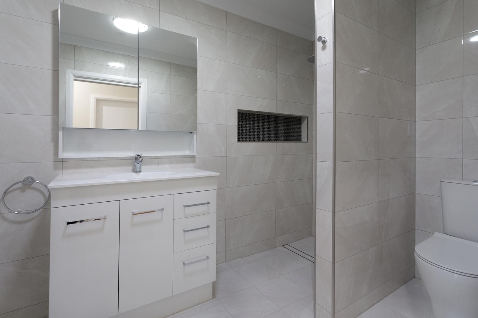 A Bathroom With a Sink, Toilet and Shower — Kareela Constructions In Tamworth, NSW