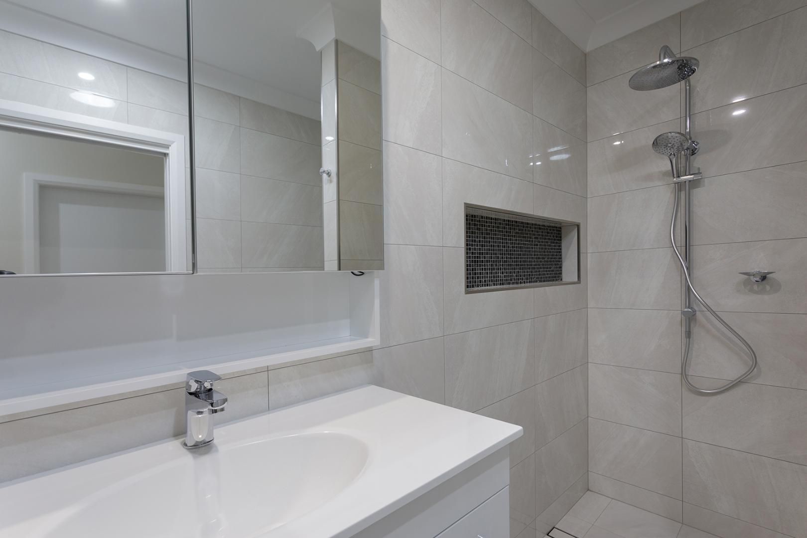 A Bathroom With a Sink, Mirror and Shower — Kareela Constructions In Tamworth, NSW