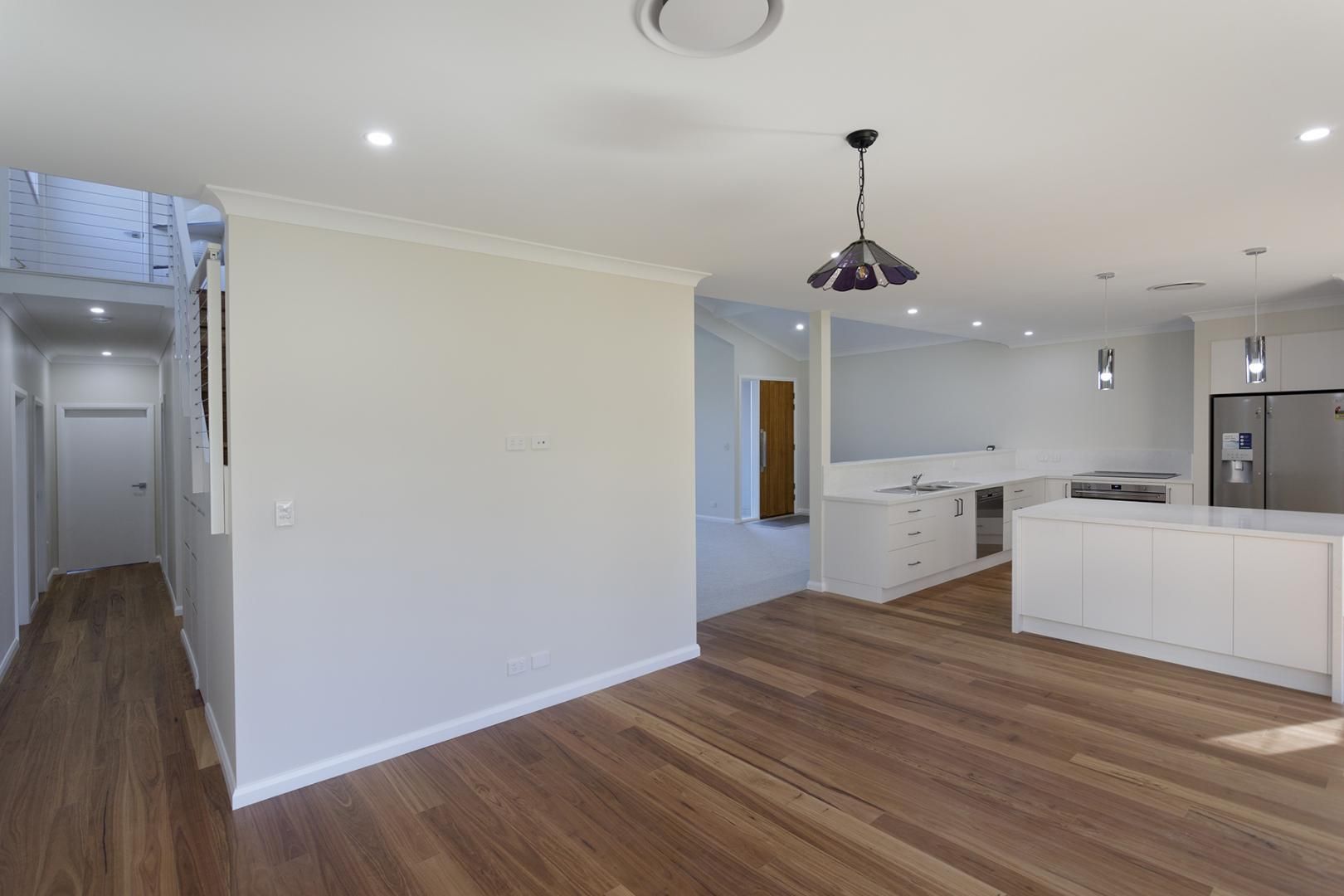 A Living Room With Hardwood Floors— Kareela Constructions In Tamworth, NSW