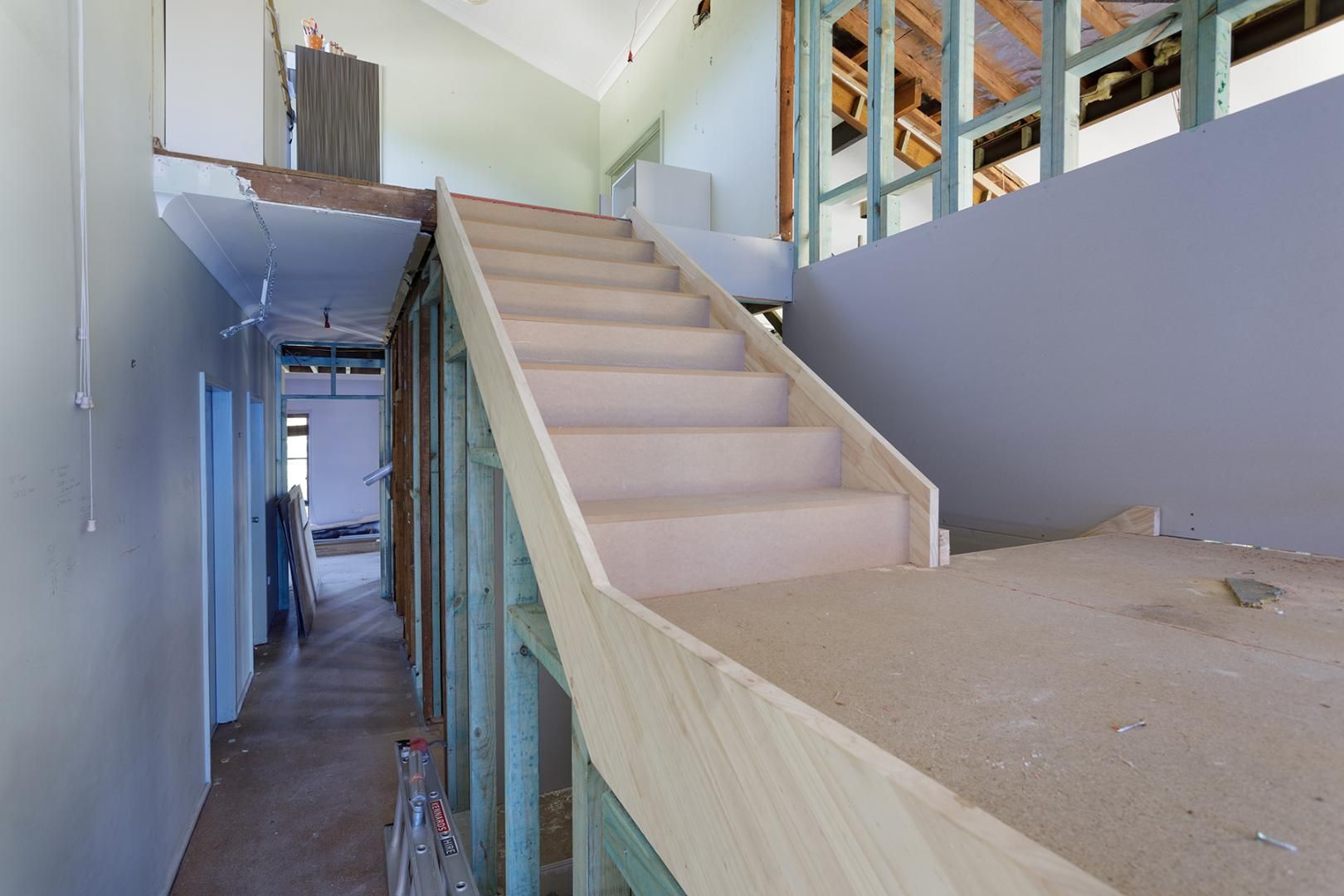 A Wooden Staircase is Being Built in a House Under Construction — Kareela Constructions In Tamworth, NSW