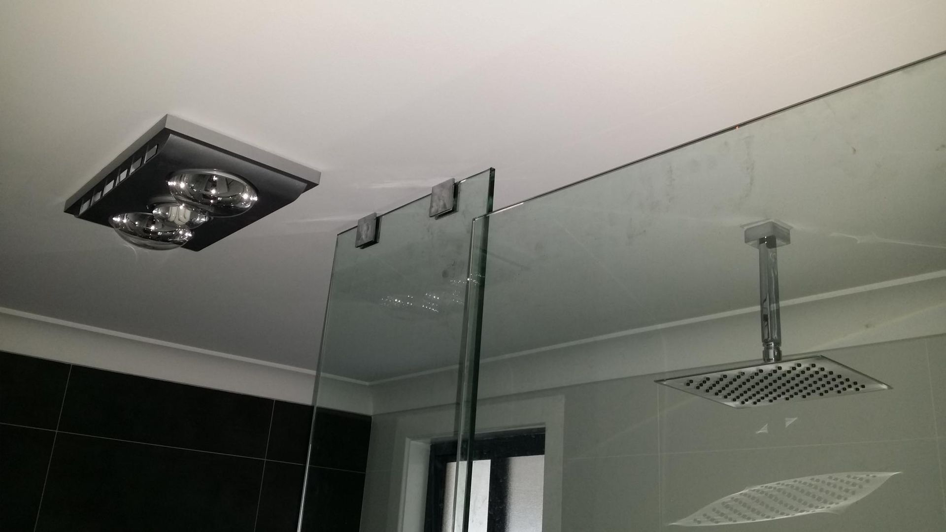 A Bathroom With a Ceiling Fan and a Shower Head — Kareela Constructions In Tamworth, NSW