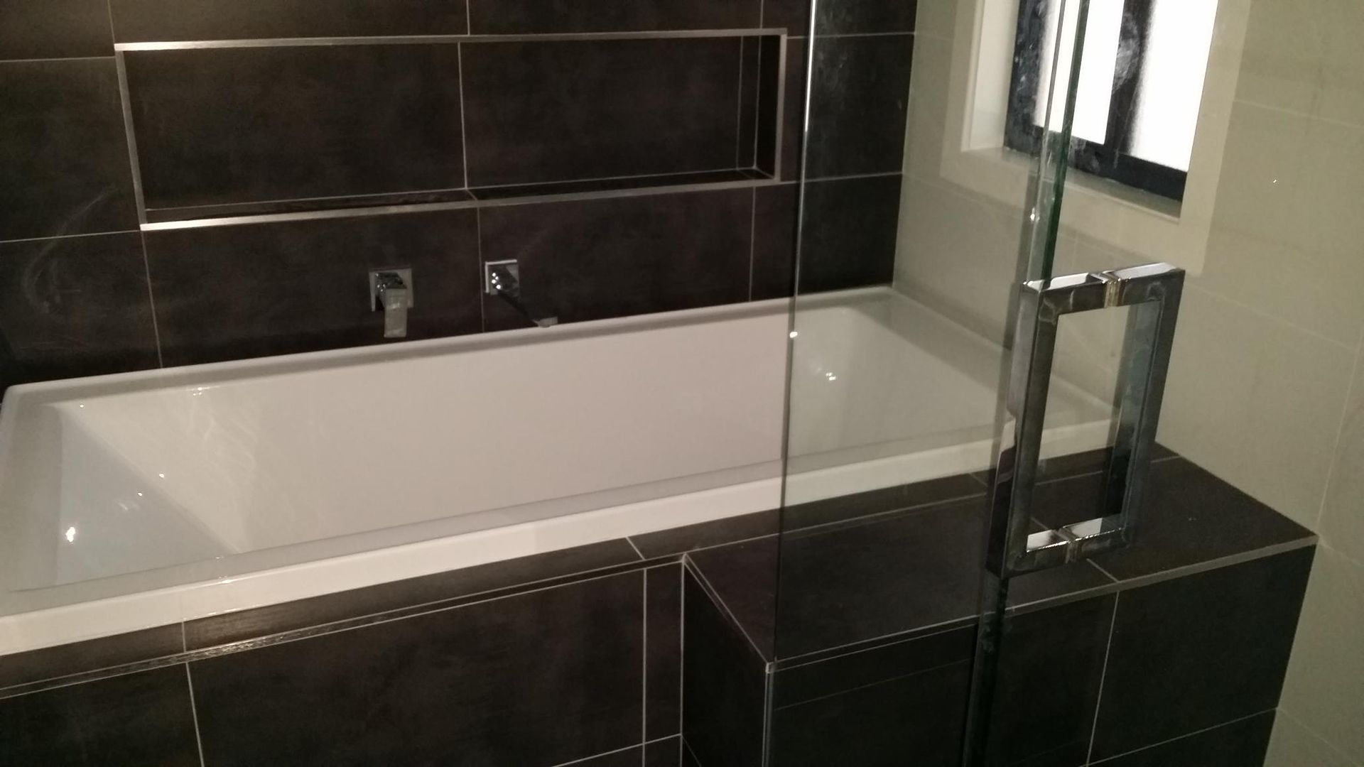 A Bathroom With a Bathtub and a Shower Stall — Kareela Constructions In Tamworth, NSW