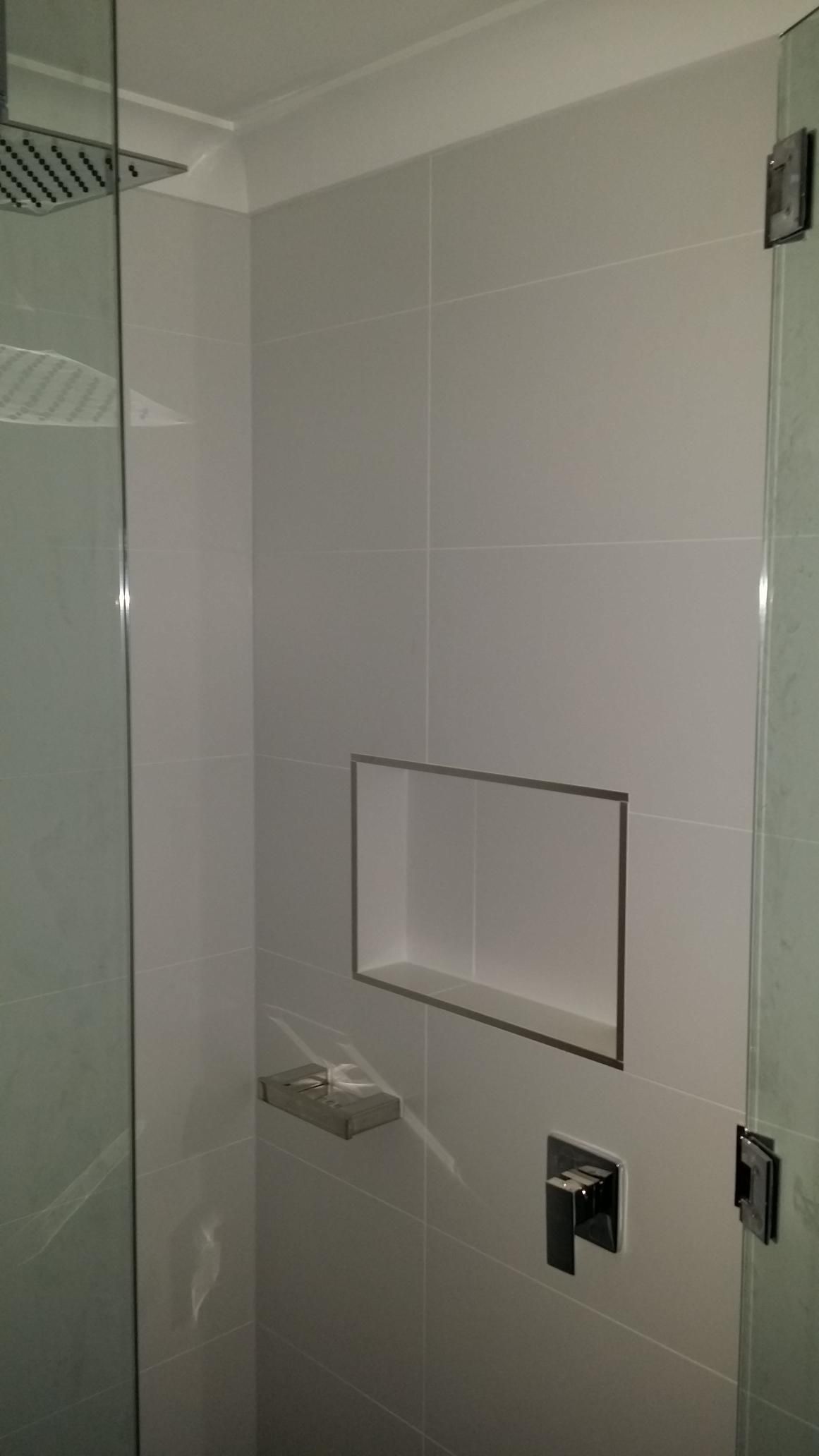 A Bathroom With a Shower and a Shelf in the Wall — Kareela Constructions In Tamworth, NSW