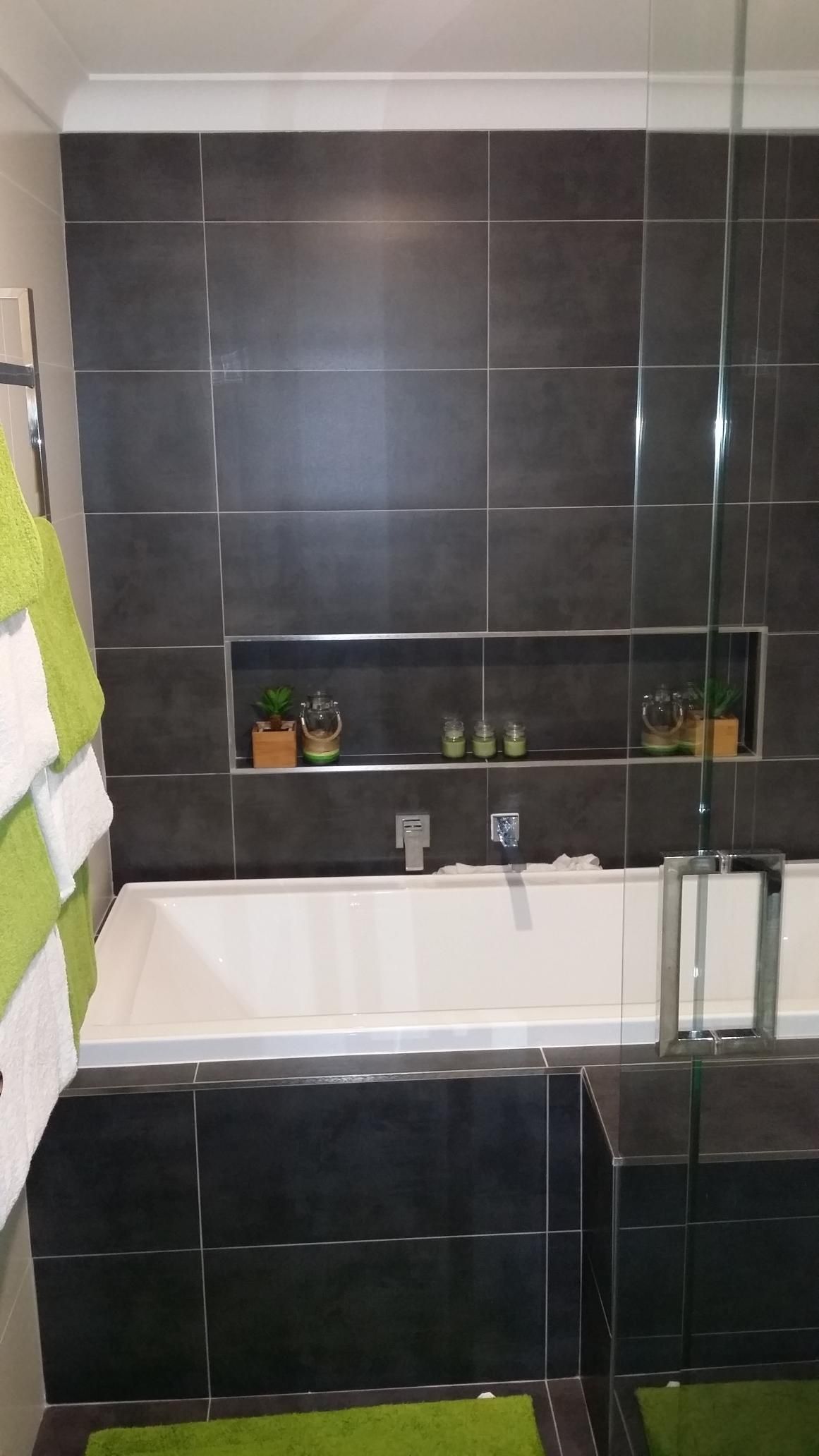 A Bathroom With a Bathtub and a Glass Shower Door — Kareela Constructions In Tamworth, NSW