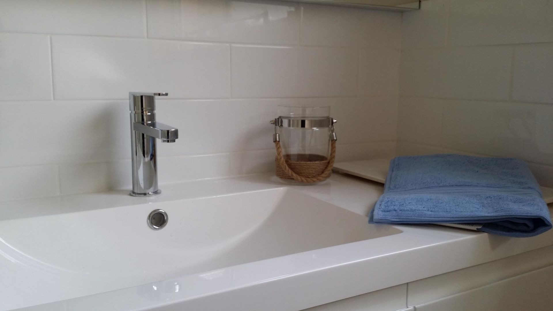 A Bathroom Sink With a Faucet and a Blue Towel on the Counter — Kareela Constructions In Tamworth, NSW