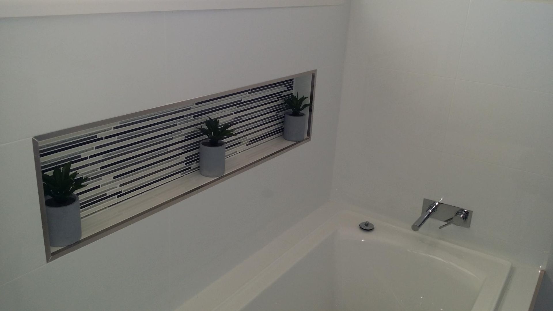 A Bathroom With a Bathtub and a Niche With Potted Plants in It — Kareela Constructions In Tamworth, NSW