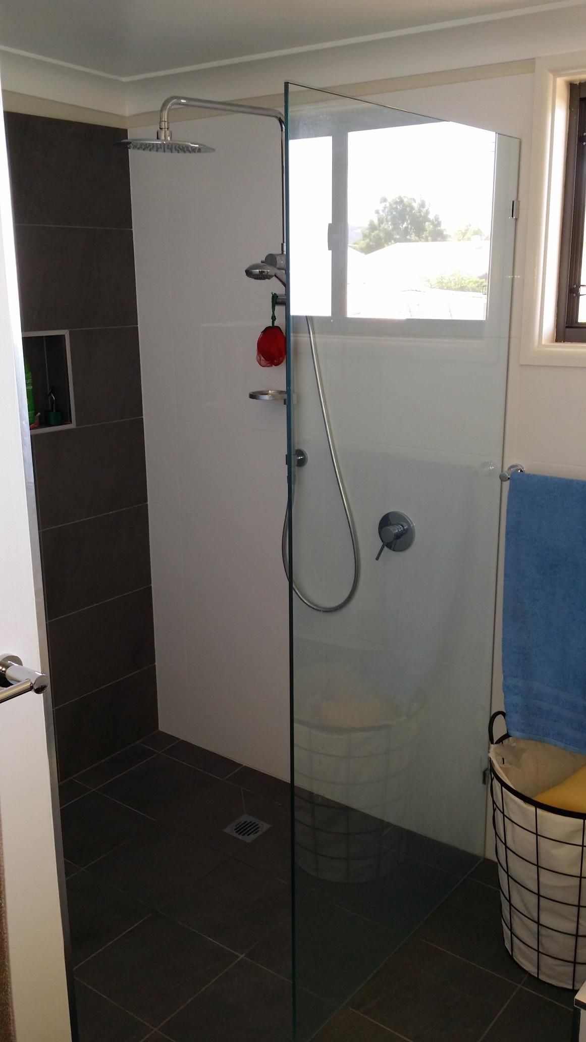 A Bathroom With a Walk in Shower and a Window — Kareela Constructions In Tamworth, NSW