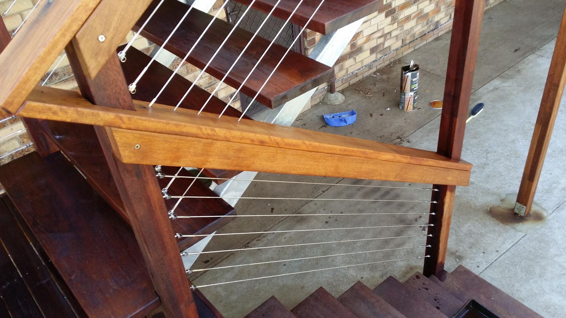 A Wooden Staircase With a Stainless Steel Railing — Kareela Constructions In Tamworth, NSW