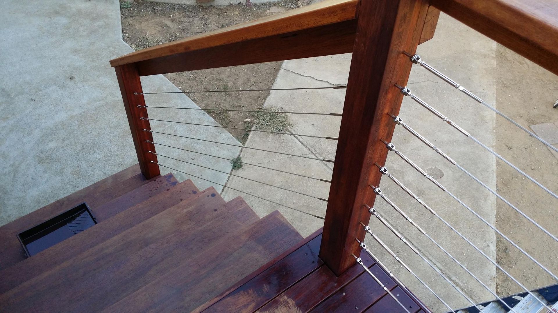 A Wooden Staircase With a Stainless Steel Railing — Kareela Constructions In Tamworth, NSW