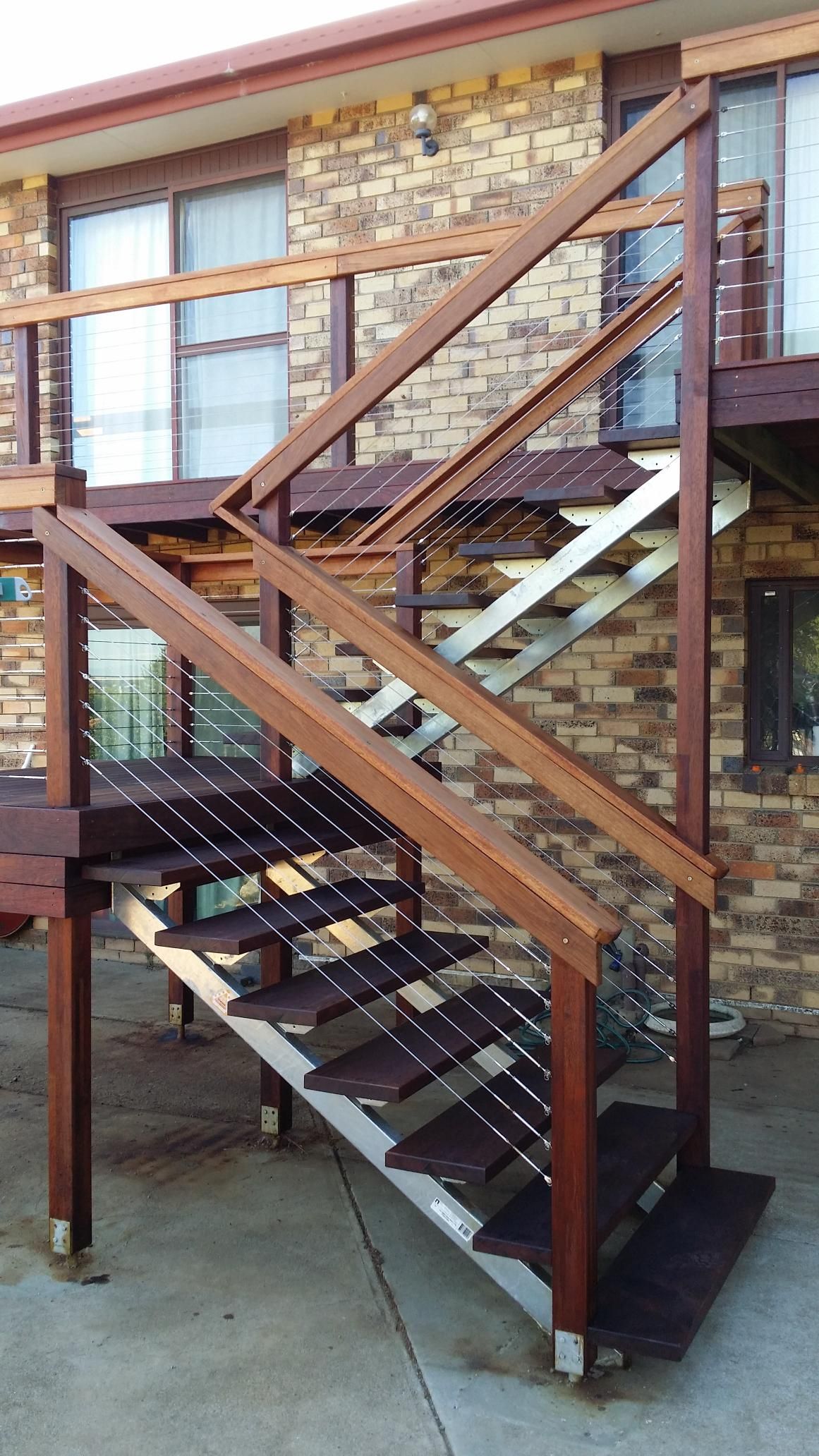 A Set of Wooden Stairs Leading Up to a Brick Building — Kareela Constructions In Tamworth, NSW